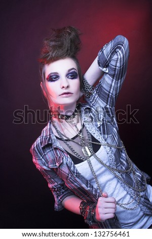 Punk. Young woman with smokey eyes and with artistic hairstyle.
