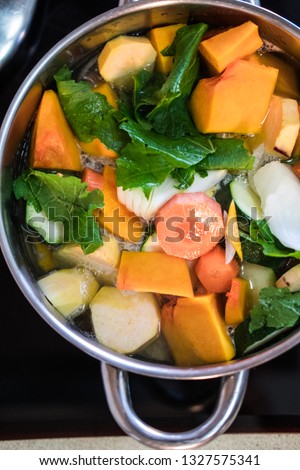 Vegan soup preparation, step 6 - Putting the veggies in the pot.