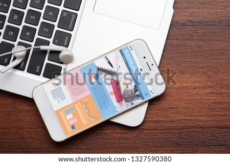 Close up view of keyboard, earphones  and smartphone with statistics, charts and graphic information about company growth. Business concept. All screen graphics are made up by us