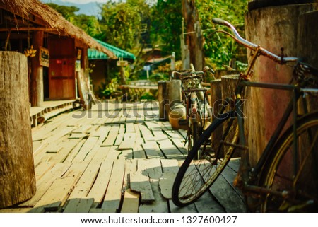 Vintage bicycle on wooden floor in Thailand. Classic vintage bicycle parked in an old gallery.