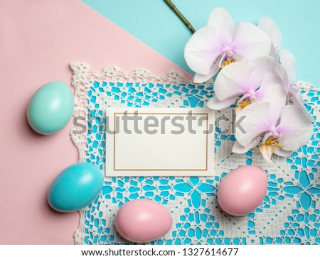 Pink blue easter eggs on pastel color background with space for text and orchid