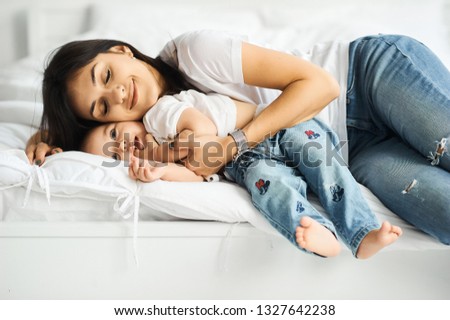 happy loving family. mother playing with her children in the bedroom