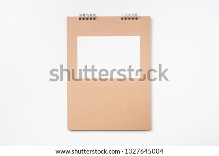 Design concept - Top view of kraft notebook, photo frame and pen isolated on white background for mockup