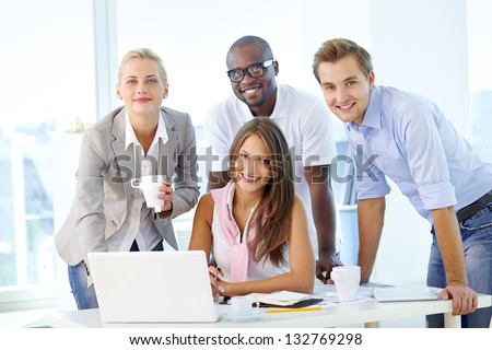 Friendly young people working as a business team Royalty-Free Stock Photo #132769298