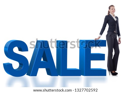 Woman standing next to SALE word