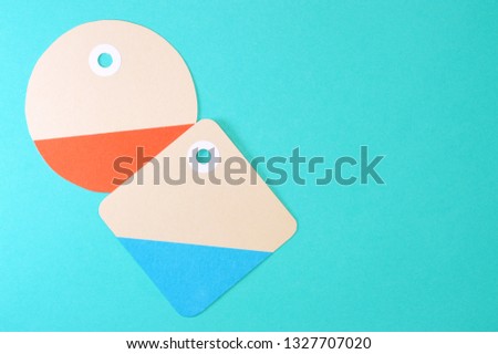 Paper tag on color background, ideal for your shopping projects or business topics.