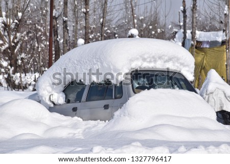 a vehicle covered with snow in kashmir