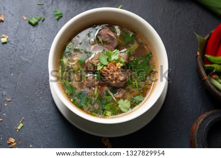 Asian bone soup or sup tulang, popular traditional malay dish. Top view flat lay.