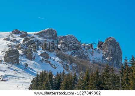 Snowy hill peak. Panoramic view of snow mountains.