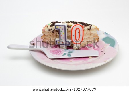 Dessert - a piece of cake with candles and a spatula for the cake.