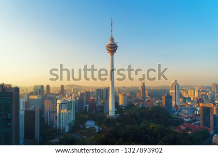 Menara Kuala Lumpur Tower with sunset sky. Aerial view of Kuala Lumpur Downtown, Malaysia. Financial district and business centers in urban city in Asia. Skyscraper and high-rise buildings at noon. Royalty-Free Stock Photo #1327893902