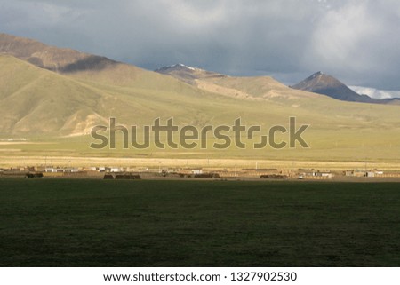 Beautiful landscape of mountains in Qinghai, China. Sunny blue sky with clouds. Stunning view of Tibetan Plateau. Taken from Qinghai-Tibet railway. 