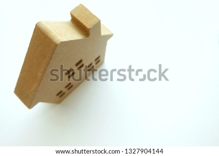 Close up of mini wooden house on white background.
