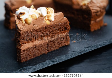 Delicious chocolate cake on table oN black  background, closeup