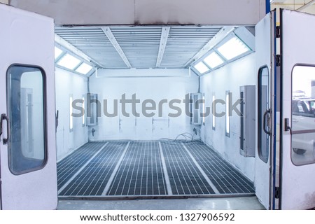 car body and paint room. Spray paint cabinet in a car repair station. Auto service concept. High-quality painting of vehicles in a room with a filter and good light Royalty-Free Stock Photo #1327906592