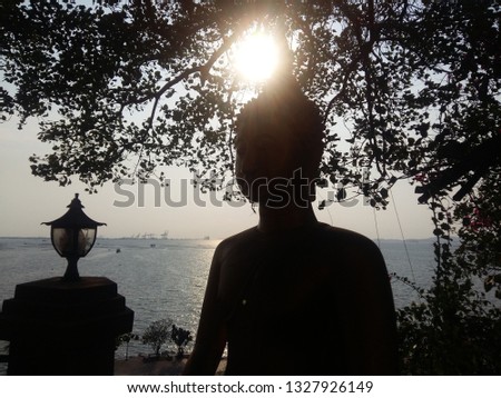 Buddha statue with big sun flair on the head