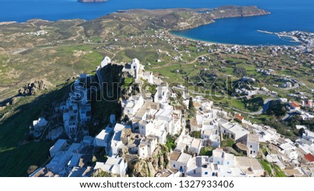 Aerial drone photo of picturesque main village of Serifos island built on a cliff  with views to the Aegean blue sea at spring, Cyclades, Greece
