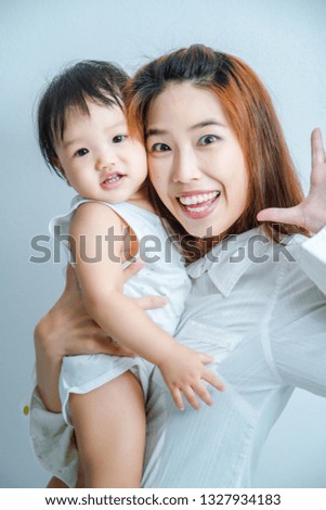 Family, Happy asian mother and baby daughter play in action