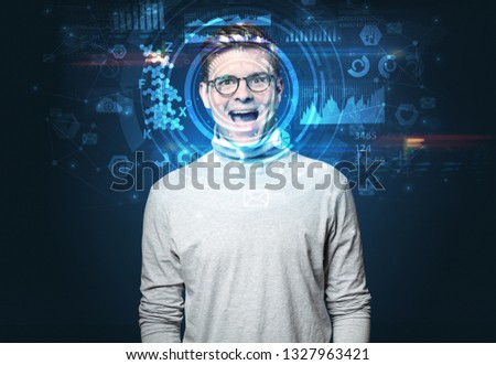 Facial recognition system. Young man on dark background, face recognition concept