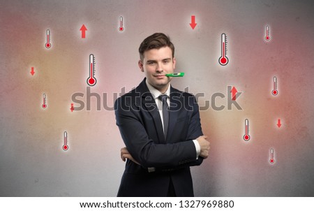 Young tired businessman with thermometer and fever concept