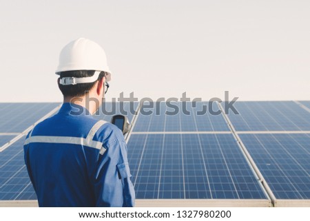 engineer using thermal imager to check temperature heat of solar panel 
