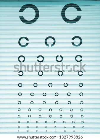 Table of eye examination on roller shutters. Abstract background.