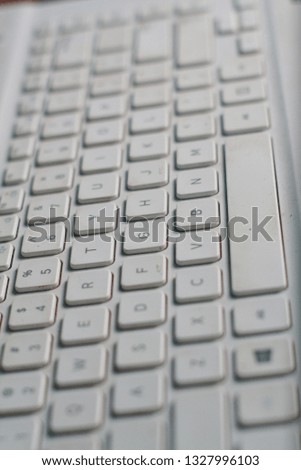 Close up of keys of light white laptop keyboard 
