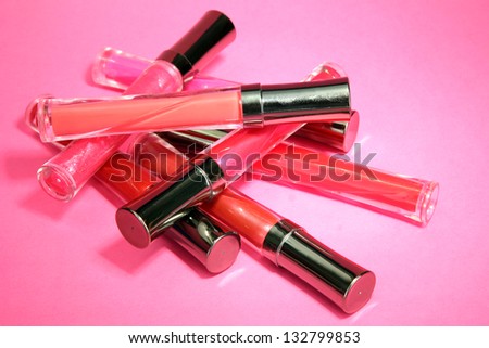 beautiful lip glosses, on pink background