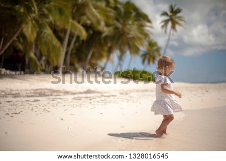 Cute little baby girl walking on the beach