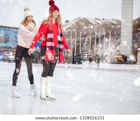 Image of group funny women ice skating outdoor at ice rink stadium. Almaty. Winter activities for good mood and healthy mind. Healthy lifestyle and sport