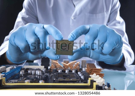 The scientist holds the computer part