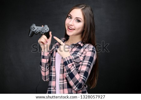 Beautiful girl with joystick on black background