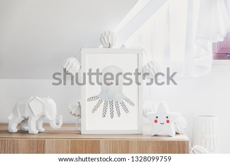 Stylish and cute nursery interior with mock up photo frame , star , elephant figure and cotton lapms on the wooden shelf. Bright and sunny room with white background wall. 
