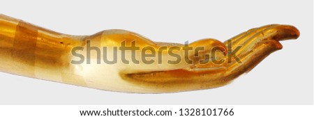 Golden hand of Buddha statue isolated on white background