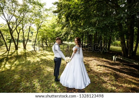 Happy wedding couple in beautiful park. Wedding photography.