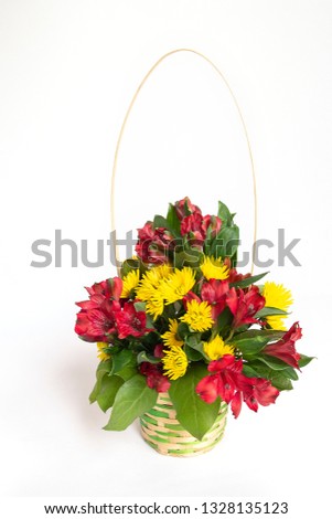 A bouquet of flowers in the wicker basket on the white background. Content for International Women's Day, Eighth March, Valentine's Day, Birthday.