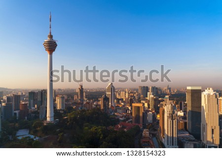Menara Kuala Lumpur Tower with sunset sky. Aerial view of Kuala Lumpur Downtown, Malaysia. Financial district and business centers in urban city in Asia. Skyscraper and high-rise buildings at noon. Royalty-Free Stock Photo #1328154323