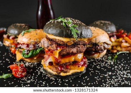 Many different burgers with ingredients on a black background