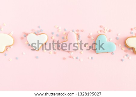 Valentine's day background. Ginger cookie in shape heart on pastel pink background. Valentine day concept, design. Flat lay, top view, copy space 