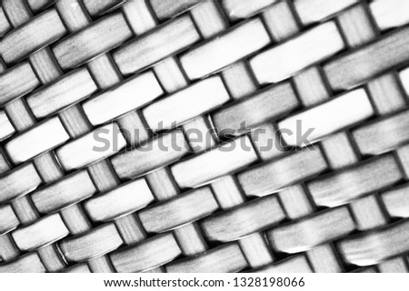 Closeup of beautiful Asian hand crafted bamboo weaves in black and white tone for grunge pattern and background. Art and traditional rattan weaved pattern concept. Monochrome seamless pattern