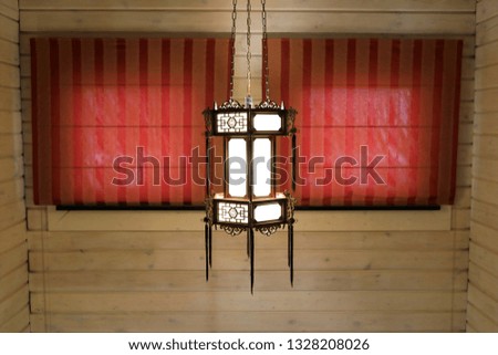 Chinese lamp on the background of wooden wall
