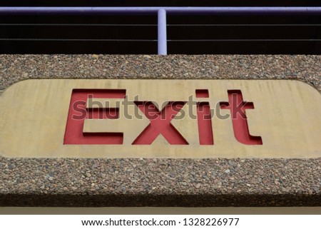 The exit sign of a downtown parking garage