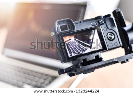 Detail of modern laptop via new photo digital cameras screen. LCD display live view on a High Definition TV camera with blur background. Business chart or graph.