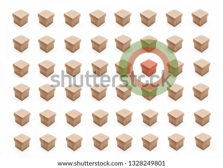 Red cardboard box isolated by circle from numerous browns. Concept image of standing out from group.