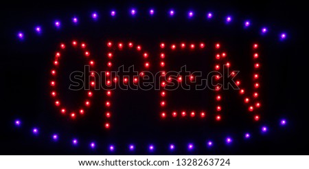 Open sign / sighboard for display window of a shop or restaurant. LED technology gives bright light and energy saving. Glowing dot elements on black backround forming the word.