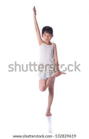 Little girl practicing yoga isolated on white background