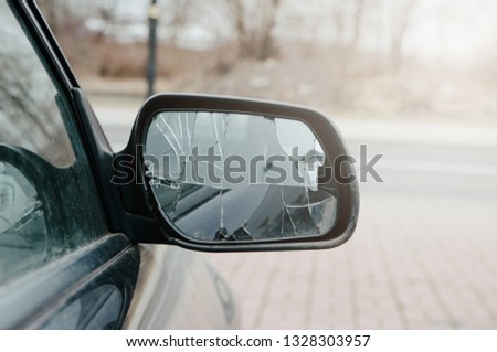 Broken car mirror. The car mirror is damaged, broken glass. Concept of accident, road collision. Damage to the side mirror, bad driving, problems with the car. Royalty-Free Stock Photo #1328303957