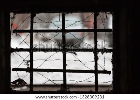 Winter day. The picture was taken from the basement through the bars. Picture taken in Ukraine, Kiev region. Color image. Horizontal frame