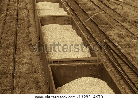 Rail system. Transportation of passengers and cargo. Junction. View from above. Cars with titanium ore. Export. Picture taken in Ukraine, Kiev region. Black and white image. Sepia