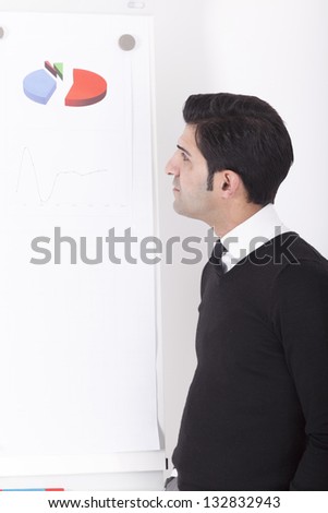 office worker (consultant) giving a presentation on a flipchart. Studio shot on a white background.